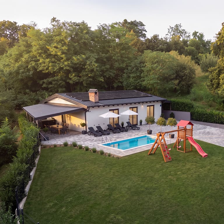 Villa Grandis seen from the garden, with the pool and terrace